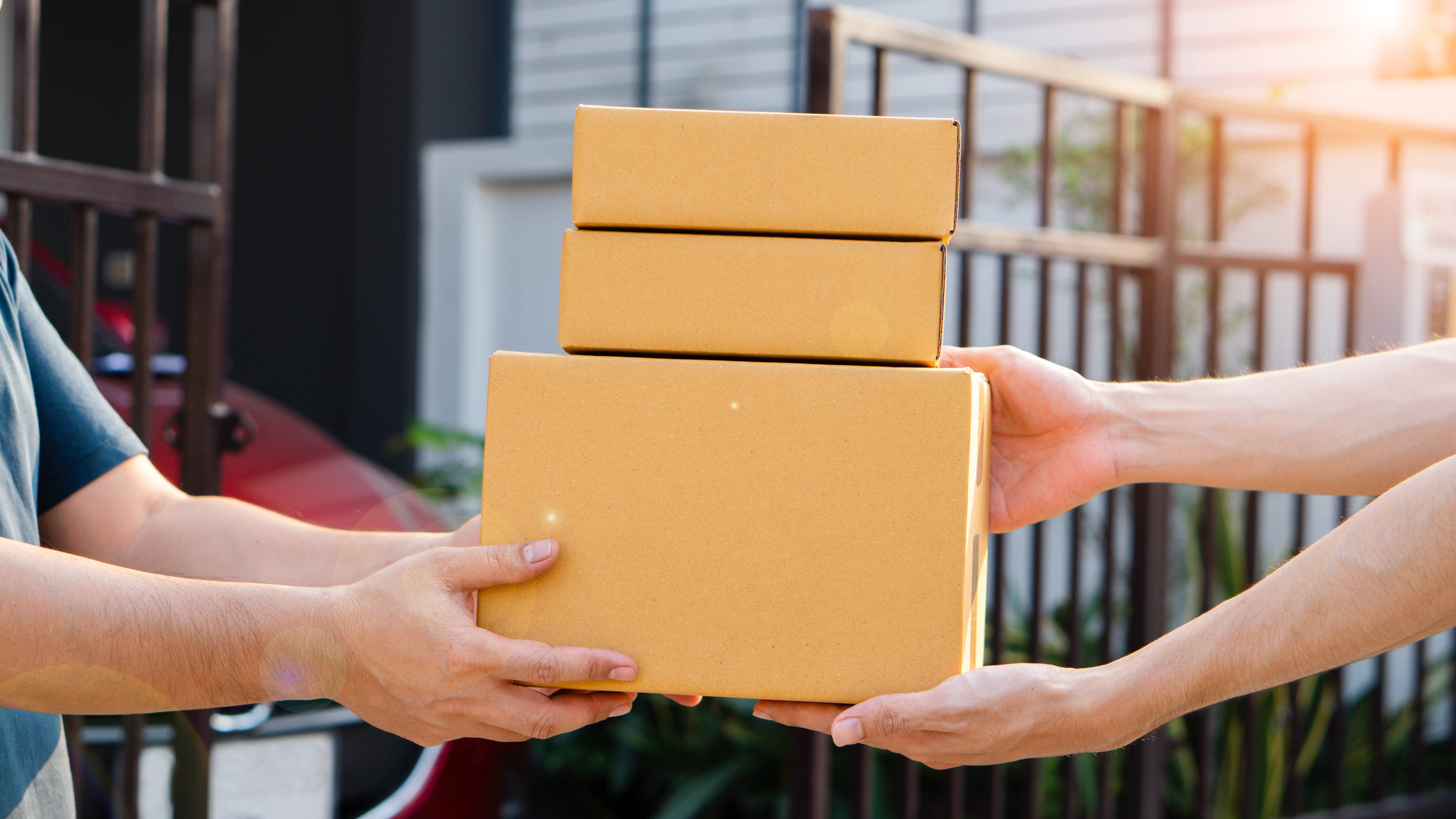 Man receiving parcel from delivery man, parcel delivery service for work from home people, parcel delivery with good depth of field